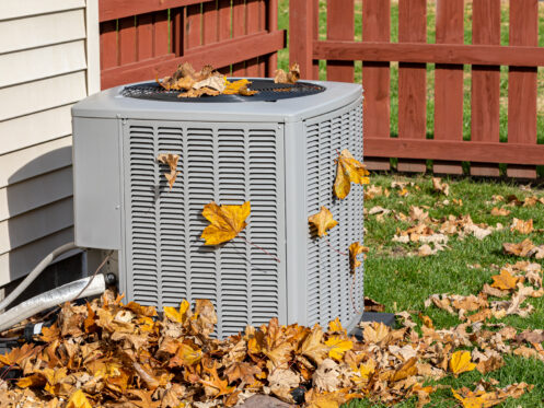 AC unit surrounded by dead leaves